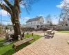 Back of property with a lawn and a patio