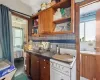 Kitchen with decorative backsplash, white stove, dark wood-type flooring, and sink