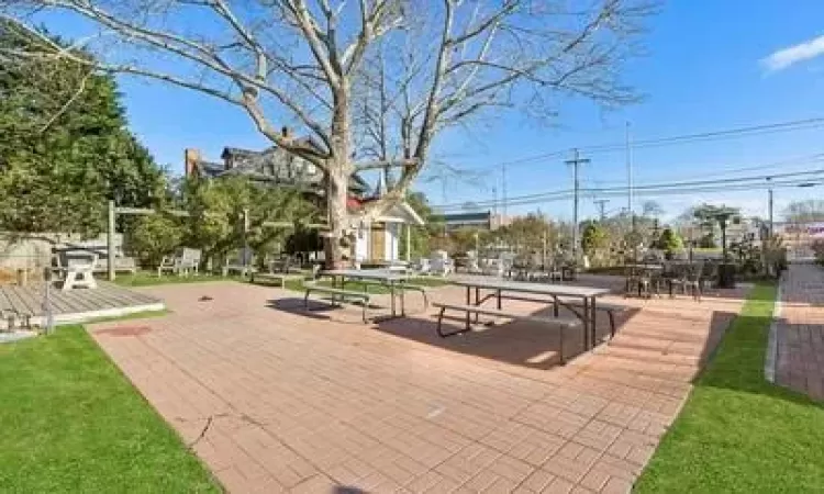 View of home's community with a wooden deck and a yard