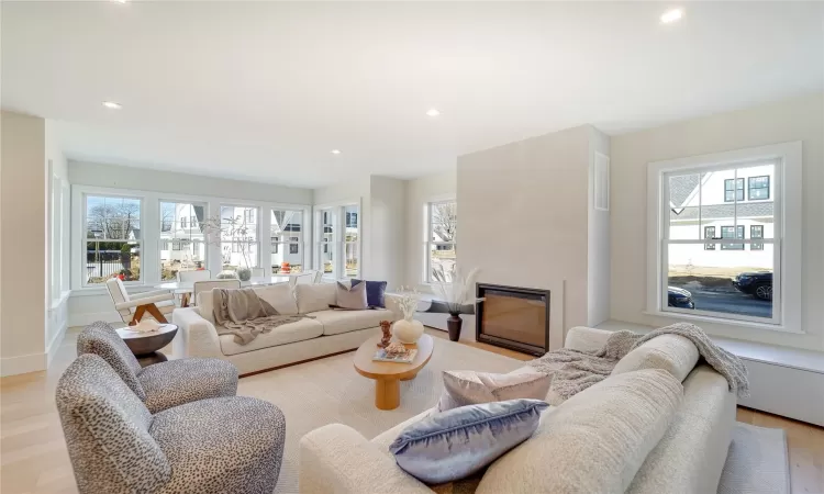 Living room featuring a large fireplace and light wood-type flooring