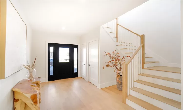 Entrance foyer with light hardwood / wood-style flooring