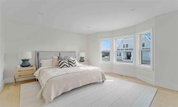 Bedroom with light wood-style flooring and baseboards