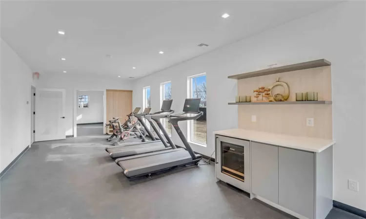 Exercise area with wine cooler, visible vents, and recessed lighting