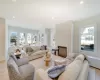 Living area featuring a glass covered fireplace, visible vents, a towering ceiling, and recessed lighting