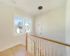 Living area with light wood-type flooring, a fireplace, a towering ceiling, and baseboards