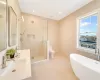 Full bathroom with tile patterned flooring, separate shower and tub, toilet, and tile walls