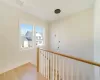 Hallway with hardwood / wood-style floors