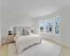 Bedroom with light wood-type flooring and baseboards