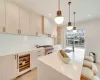 Kitchen featuring light brown cabinetry, light wood-type flooring, designer stove, and sink