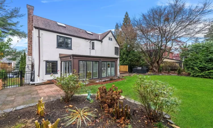 Rear view of house featuring a lawn