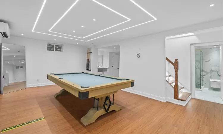 Rec room with sink, light wood-type flooring, and billiards