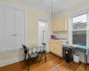 Kitchen with sink, cream cabinetry, light hardwood / wood-style floors, and ornamental molding