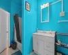 Bathroom with vanity and shower / tub combo with curtain