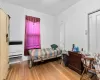 Bedroom featuring hardwood / wood-style floors and radiator heating unit