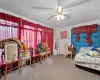 Carpeted bedroom with ceiling fan