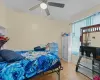 Bedroom featuring light parquet floors, ceiling fan, and crown molding