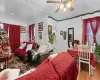 Living room featuring ceiling fan and light hardwood / wood-style floors