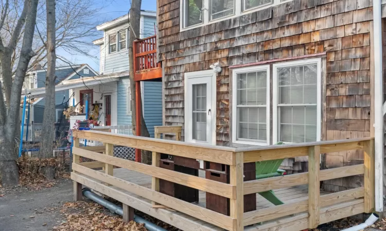 View of side of home featuring a deck