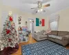 Living room with ceiling fan, hardwood / wood-style floors, and ornamental molding