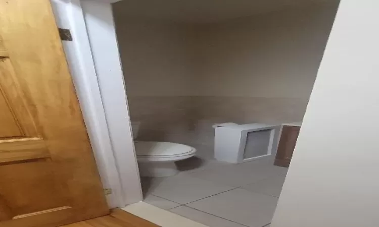 Bathroom featuring tile patterned floors and toilet