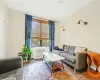 Living room with radiator heating unit and wood-type flooring