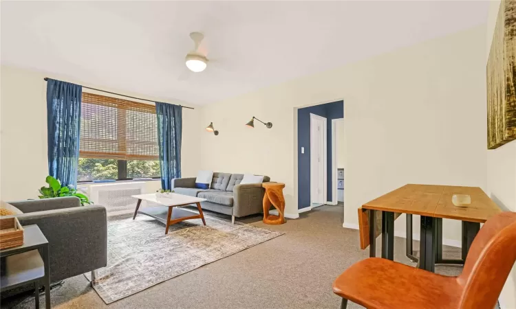 Living room with carpet and ceiling fan