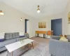 Living room featuring carpet flooring and ceiling fan