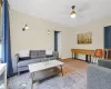 Living room featuring carpet flooring and ceiling fan