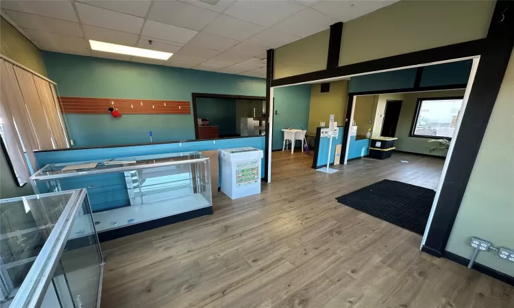 Kitchen featuring hardwood / wood-style flooring and a paneled ceiling