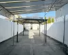 View of patio with a carport and a storage unit