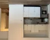 Kitchen featuring tasteful backsplash, dark wood-type flooring, exhaust hood, white cabinets, and range