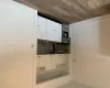 Kitchen featuring backsplash, range, sink, dark hardwood / wood-style flooring, and white cabinetry