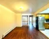 Kitchen featuring stainless steel fridge, a baseboard heating unit, and hardwood / wood-style floors