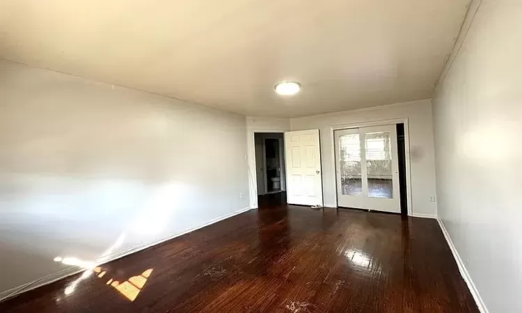 Unfurnished room featuring dark hardwood / wood-style floors and ornamental molding