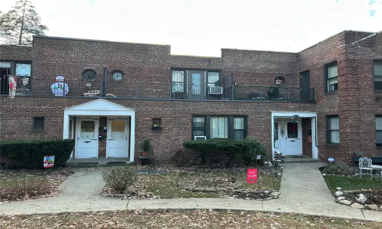 View of property featuring a balcony and cooling unit