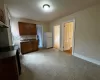 Kitchen with stove, white fridge, tasteful backsplash, and sink