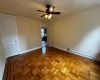 Unfurnished room featuring light parquet flooring and ceiling fan