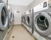 Laundry room featuring light tile patterned floors and independent washer and dryer