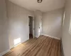 Unfurnished room with a baseboard radiator and light wood-type flooring