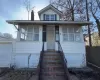 View of front of house featuring a garage and an outdoor structure