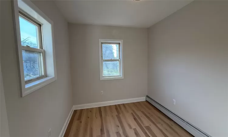 Spare room featuring light hardwood / wood-style flooring and a baseboard heating unit