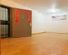 Spare room featuring wood-type flooring and a baseboard heating unit