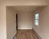 Empty room featuring light wood-type flooring and a baseboard heating unit