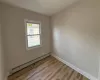 Spare room with light hardwood / wood-style flooring and a baseboard radiator