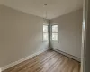 Unfurnished room featuring light hardwood / wood-style flooring and baseboard heating