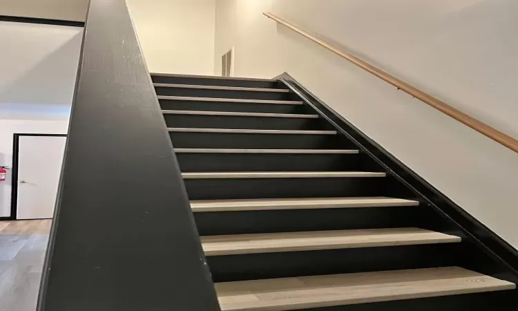 Staircase with hardwood / wood-style floors