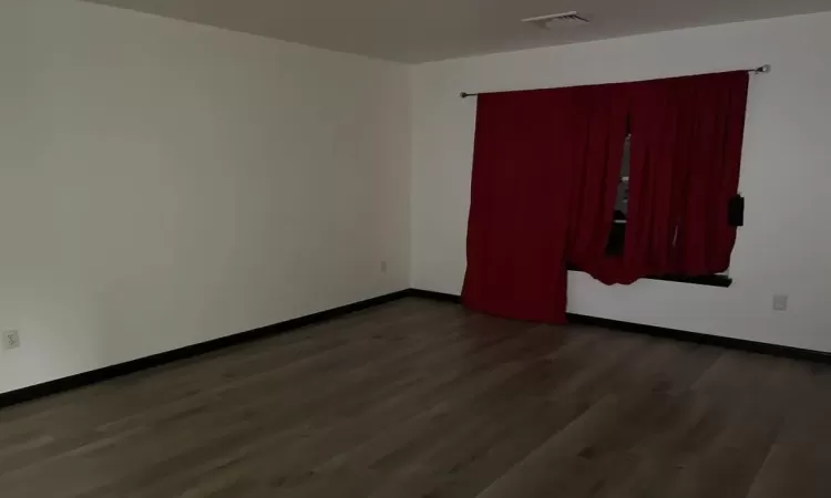 Spare room featuring dark hardwood / wood-style floors