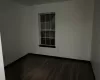 Spare room with dark hardwood / wood-style flooring