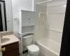 Full bathroom featuring tile patterned floors, vanity, toilet, and shower / washtub combination