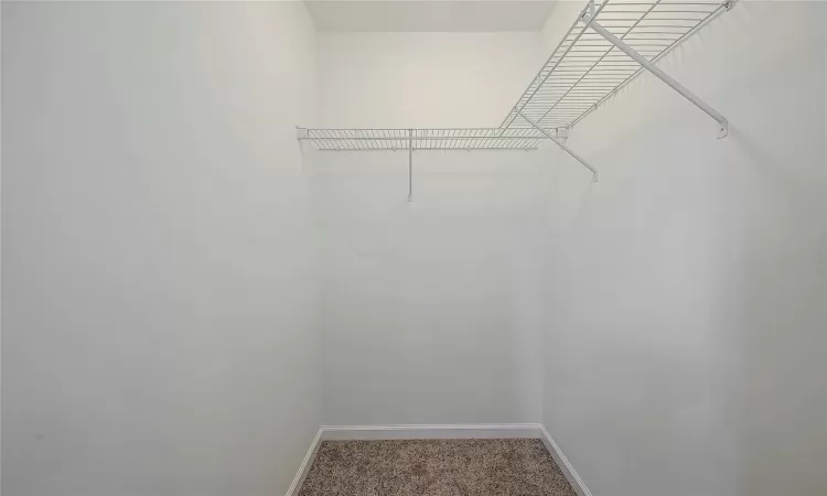 Walk in closet located in primary bedroom.